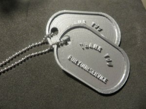 silver dog tags on black